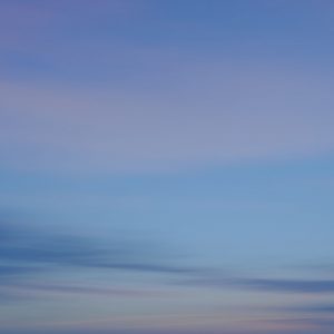 A tranquil sky showcasing soft hues of blue and pink, blending seamlessly to create a serene atmosphere.
