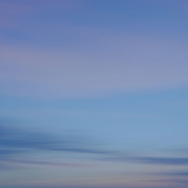 A gradient sky showcasing soft hues of blue and pastel tones, creating a calm and serene atmosphere.